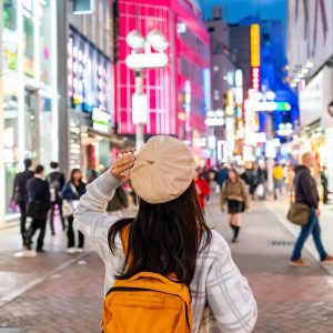 Young woman traveler enjoying and shopping at Shibuya street in Tokyo, Travel lifestyle